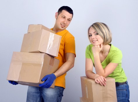 Professional movers packing and loading boxes for a home move in Beddington