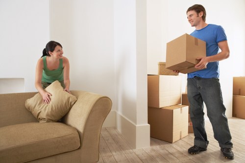Prepared moving boxes and furniture ready for removal truck hire